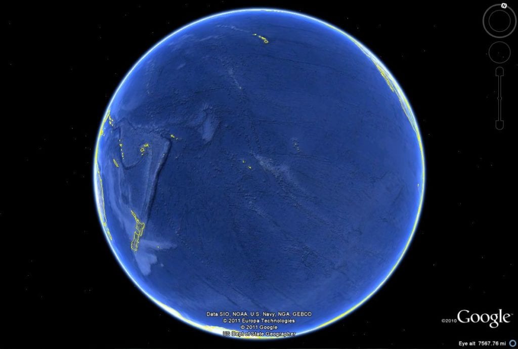 the Pacific Ocean projected on a globe, mostly showing just water and some small islands, with New Zealand in the bottom left